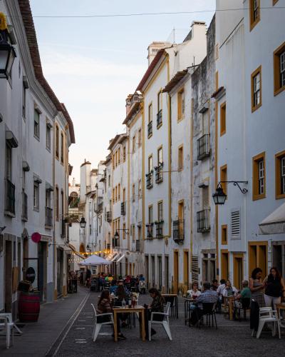 Discover the vibrant street life and historic architecture of Évora, Portugal's charming alleyway.
