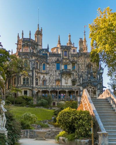 Quinta da Regaleira palace rising above its lush gardens in Sintra, Portugal